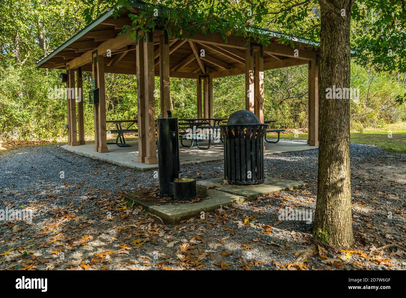 A small picnic pavilion with several tables for gatherings a water