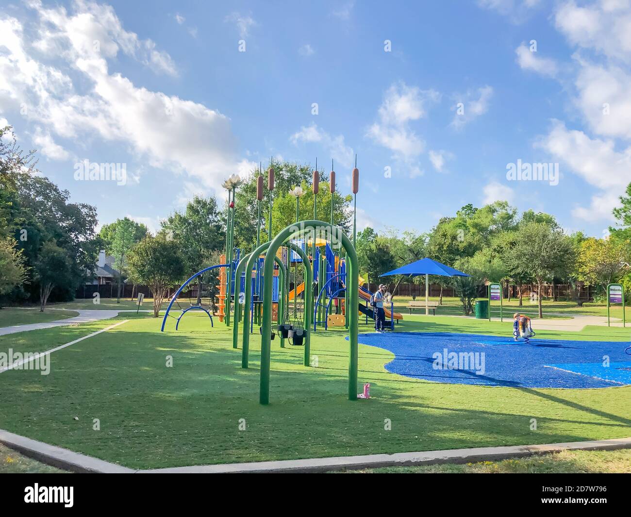 Residential area playground with sun shade sails and artificial grass