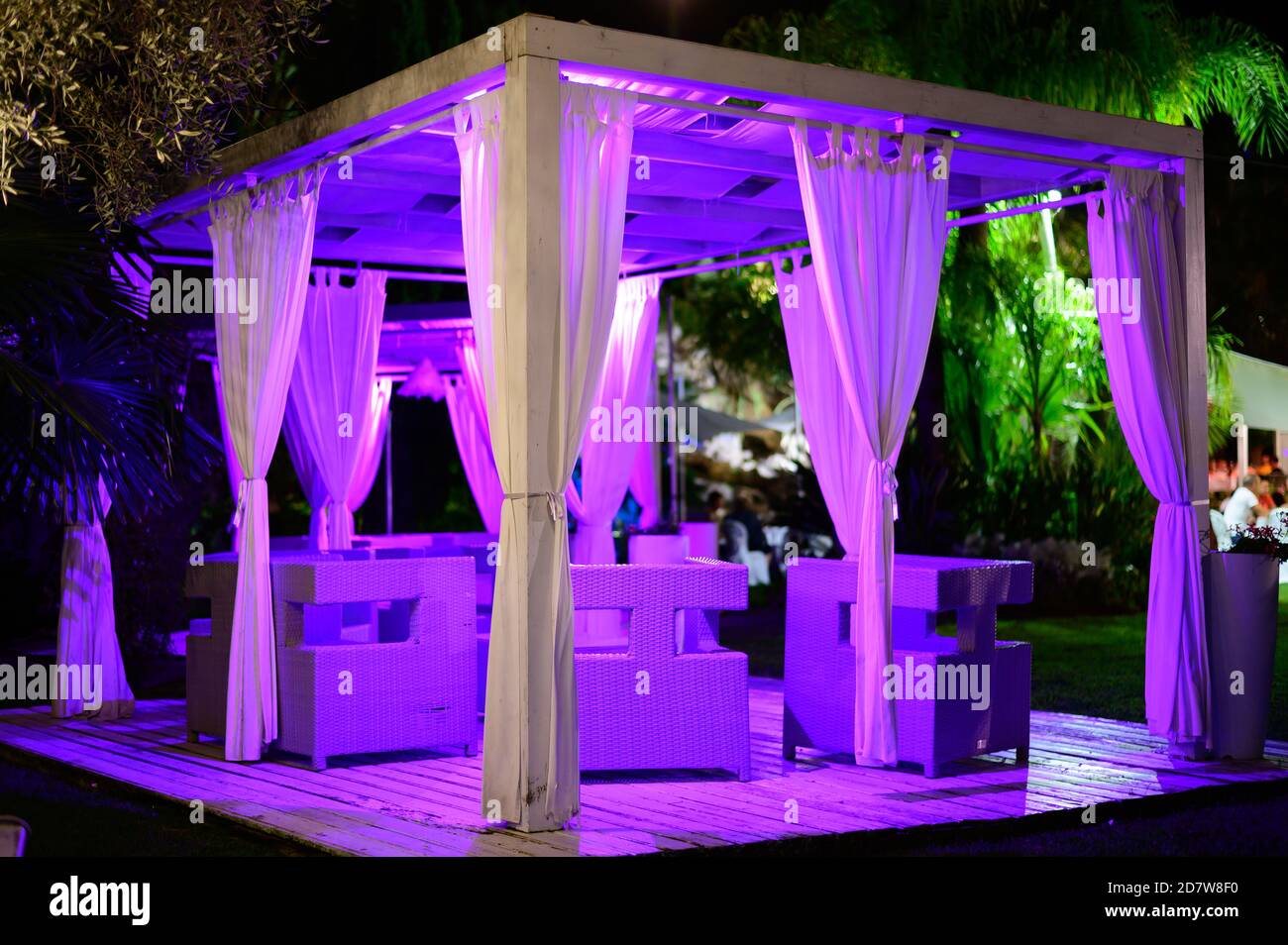 White luxury outdoor lounge terrace in green tropical garden at night Stock Photo Alamy