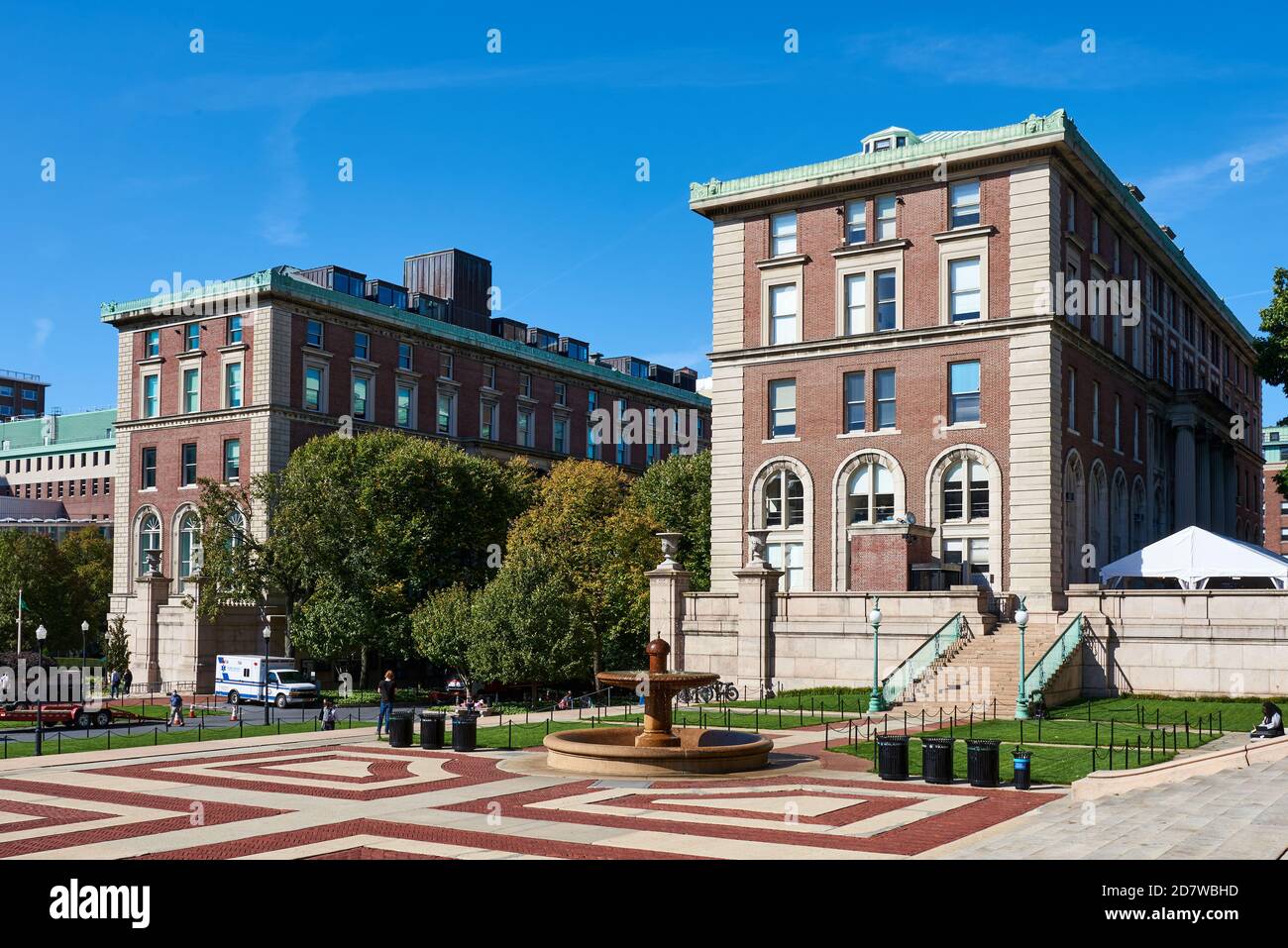 Columbia University's Dodge Hall and Pulitzer Hall seen across a plaza paved with red and white brick in a bold geometric pattern. Stock Photo