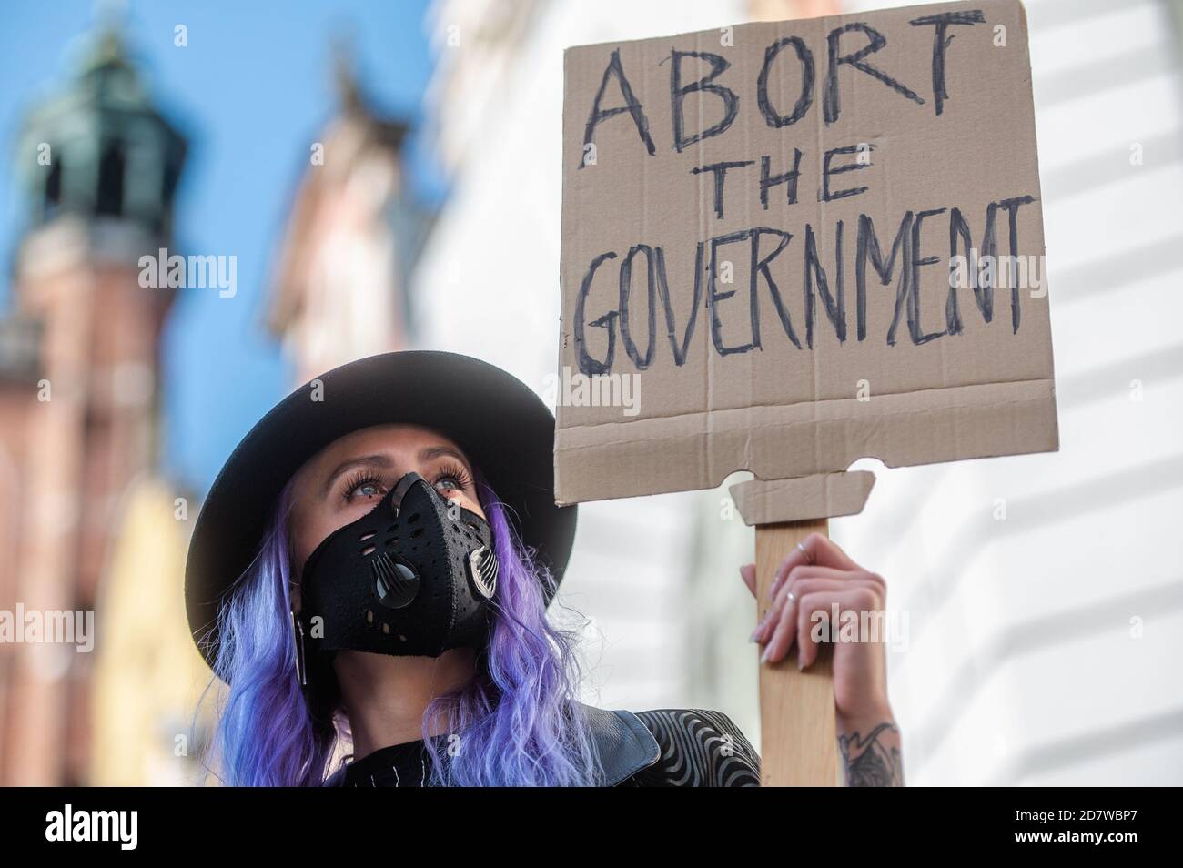 A protester wearing a face mask holds a placard during the demonstration.The Constitutional Tribunal examined the motion of a group of deputies regarding the so-called eugenic abortion. In the opinion of the Tribunal, such an abortion, performed in the event of suspicion of severe fetal defects, is inconsistent with the Constitution. Women protest against the decision. Stock Photo