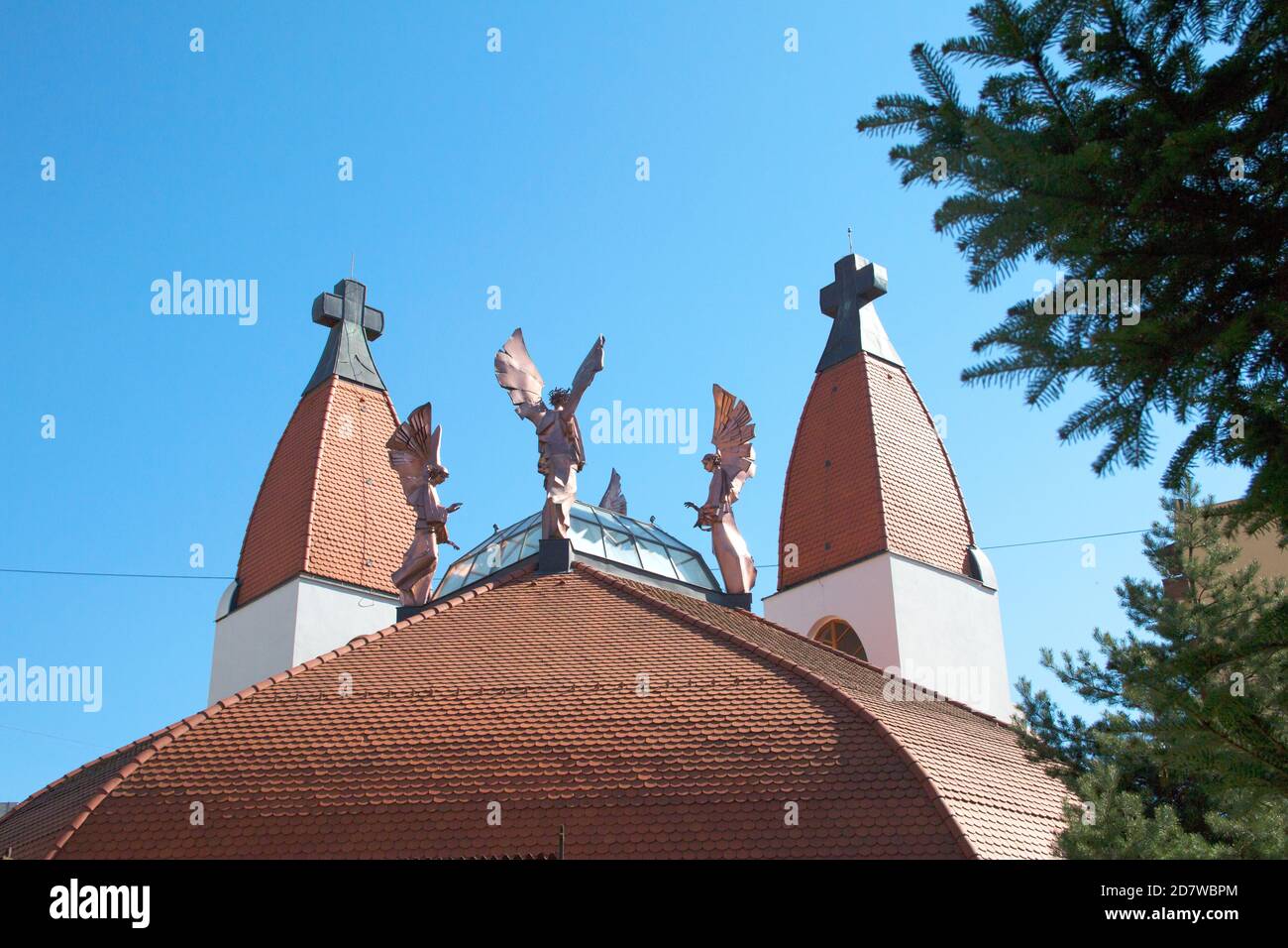 Millennium Catholic Church designed by Makovecz. The copper angel statues depict the great angels of St. Michael, Gabriel, Raphael and Uriel. Stock Photo