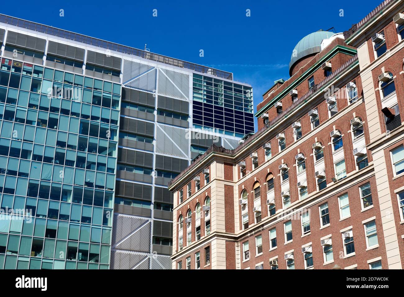 A 1927 brick and stone building is juxtaposed against a 2010 glass and steel structure on the Columbia University Morningside campus. Stock Photo