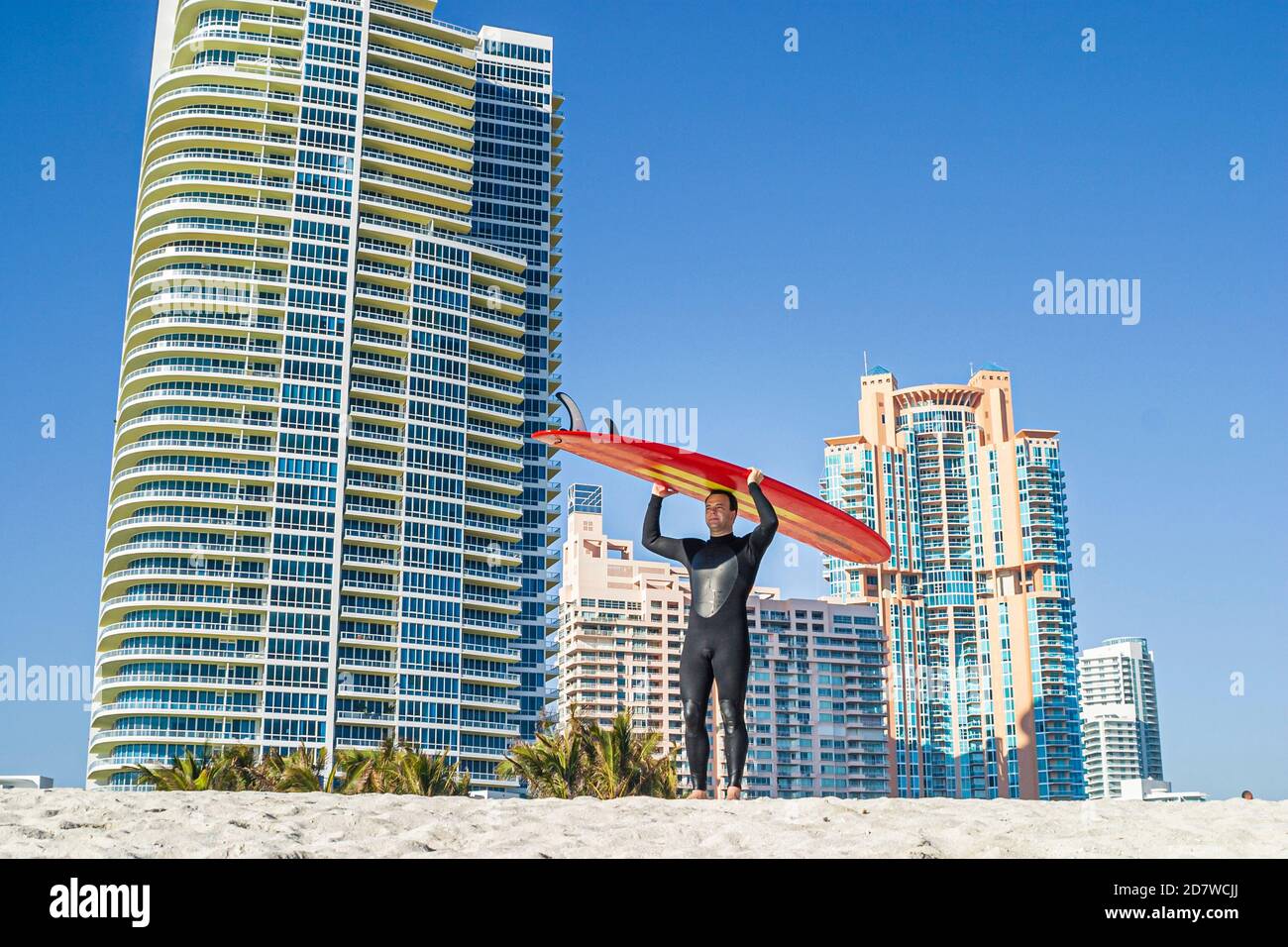 Miami Beach Florida,Atlantic Ocean seashore,lifeguard station surfer man surfboard balancing head,high rise building buildings condominiums,residences Stock Photo