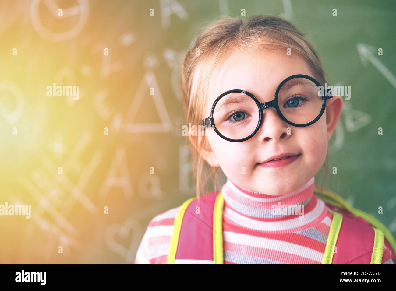 The first day at school. A little school girl stands at the chalk board. High quality photo Stock Photo