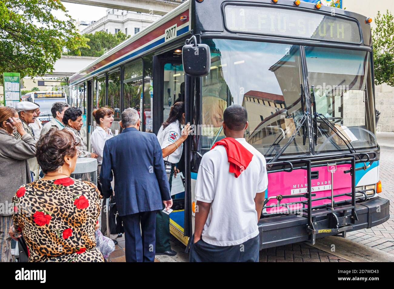 Miami Florida,residents riders board Miami Dade Transit public bus,passenger passengers transportation, Stock Photo