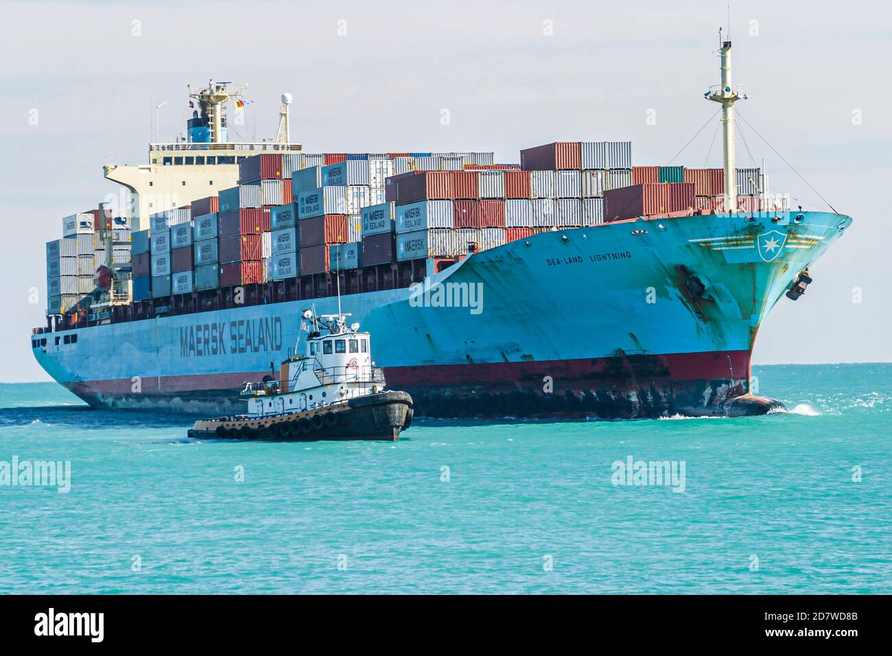 Miami Beach Florida,Atlantic Ocean cargo container ship loaded,approaches approaching arrives arriving Port of Miami tugboats, Stock Photo