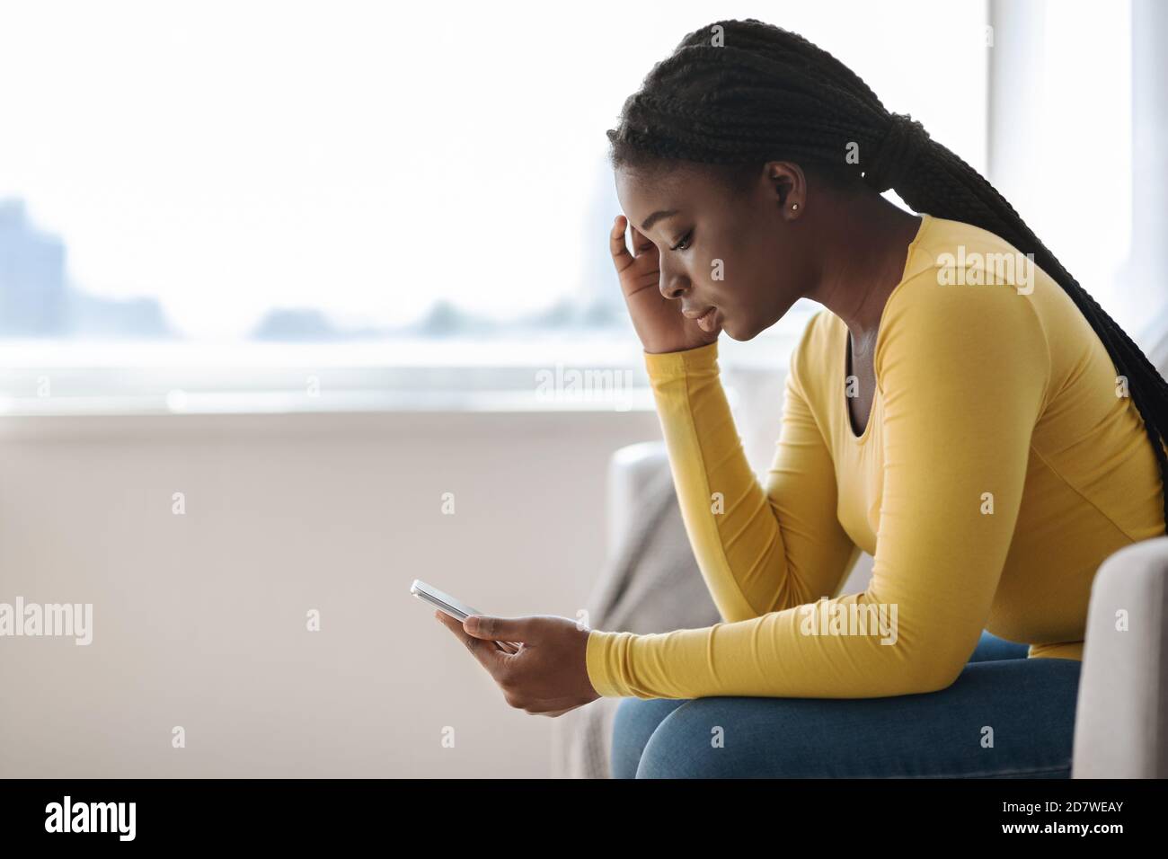 African woman sitting alone side view hi-res stock photography and ...