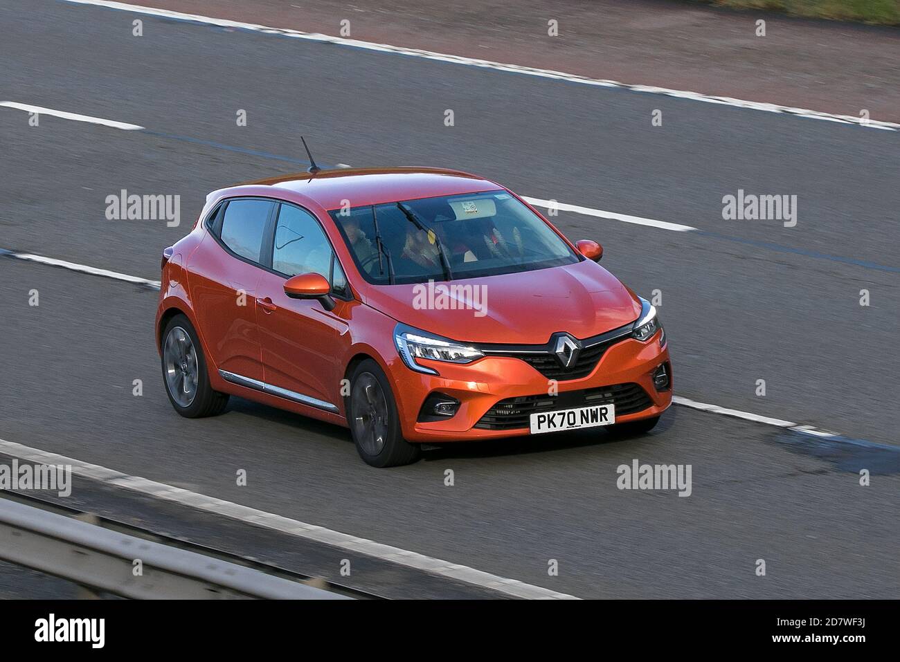 2020 orange Renault Clio Iconic TCE; moving ehicle driving on the M61 motorway near Manchester, UK Stock Photo