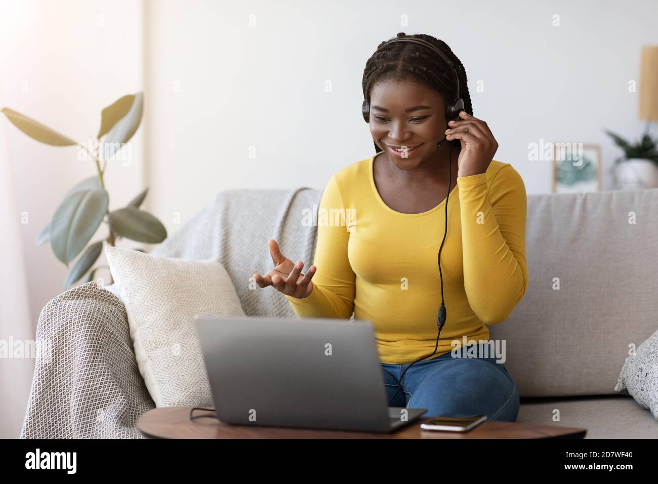 Video Call. Positive Black Lady Having Web Conference Via Laptop At Home Stock Photo