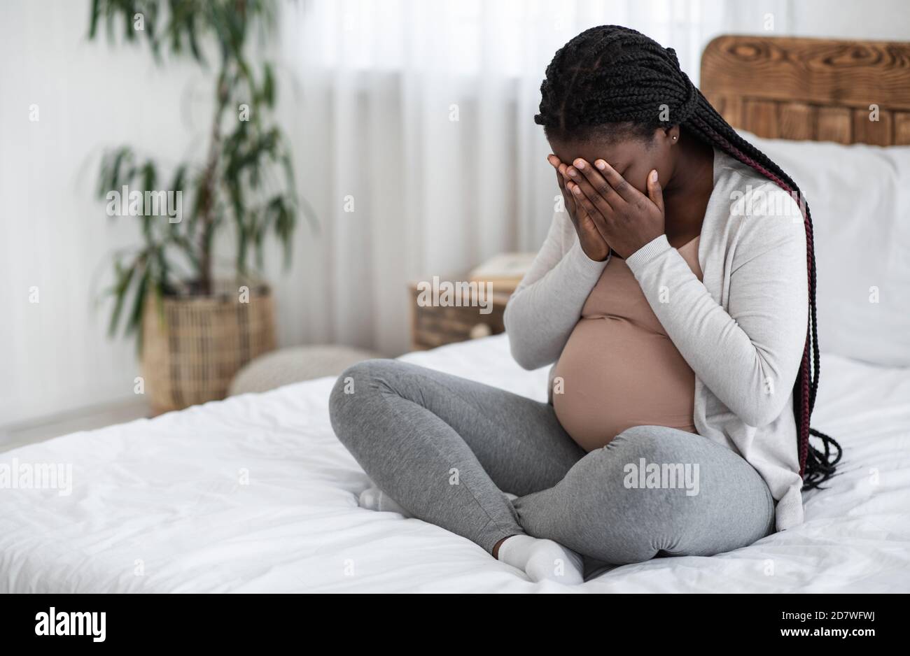 Sad Black Pregnant Woman Crying At Home, Having Maternity Depression Stock Photo