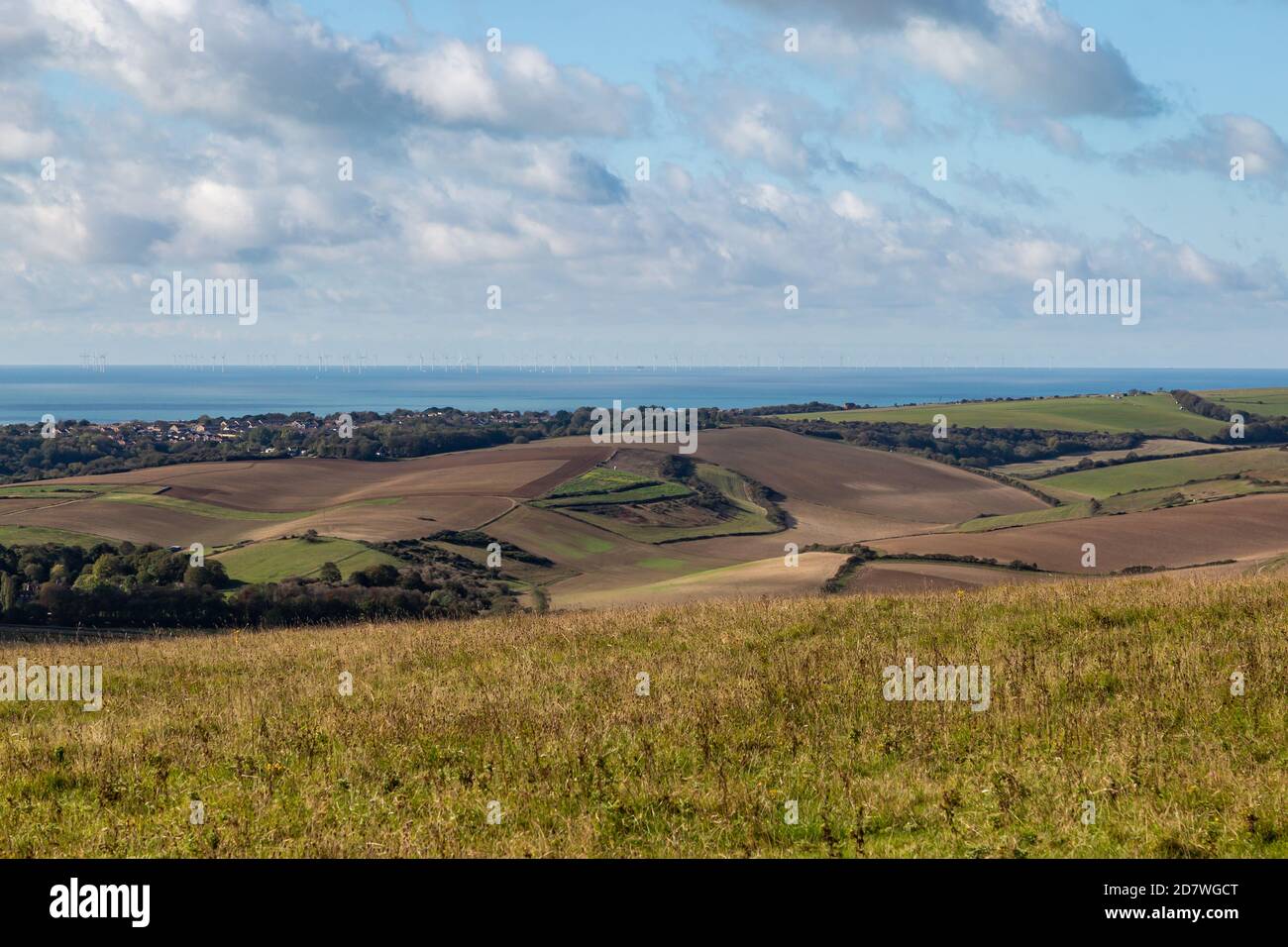 Looking out over farmland towards the sea, from Firle Beacon in Sussex Stock Photo