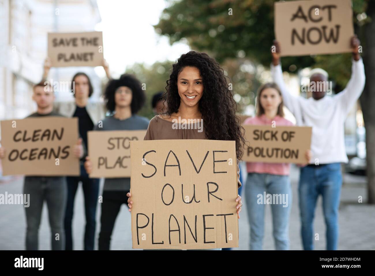 Cheerful lady with SAVE OUR PLANET placard Stock Photo