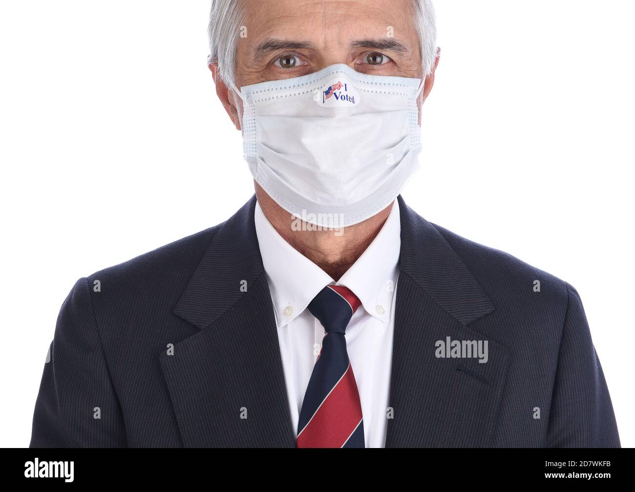 Closeup of a businessman with an I Voted sticker on the COVID-19 protective mask he wore to vote. Stock Photo