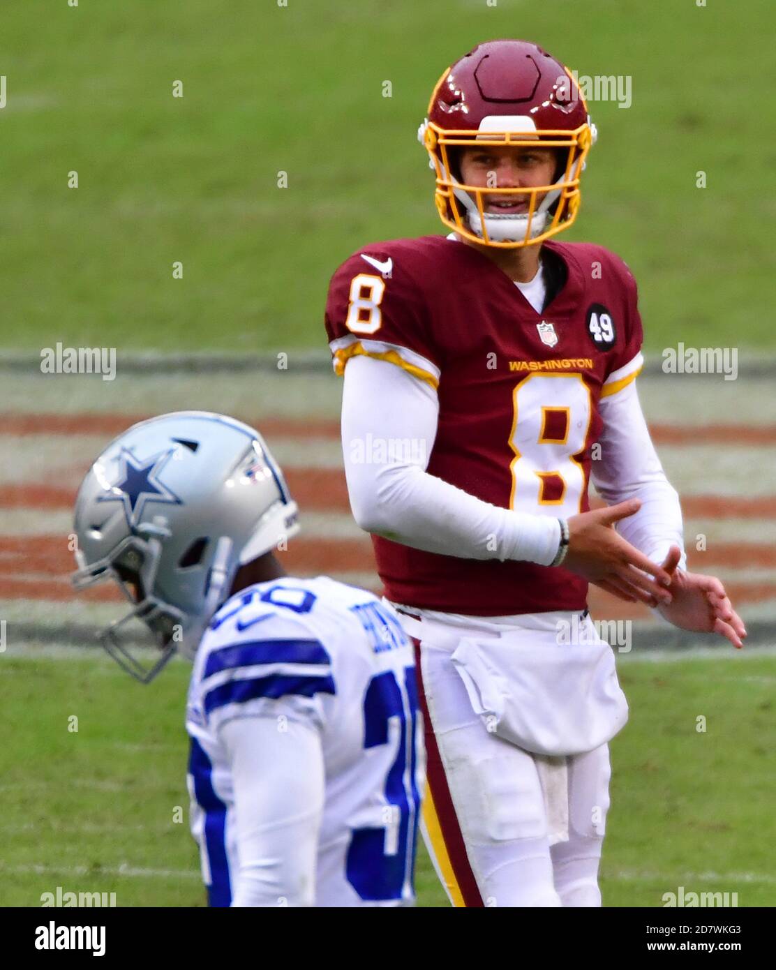 Landover, United States. 25th Oct, 2020. Dallas Cowboys quarterback Andy  Dalton (14) evades Washington Football Team linebacker Cole Holcomb (55)  during the first half of an NFL football game at FedEx Field