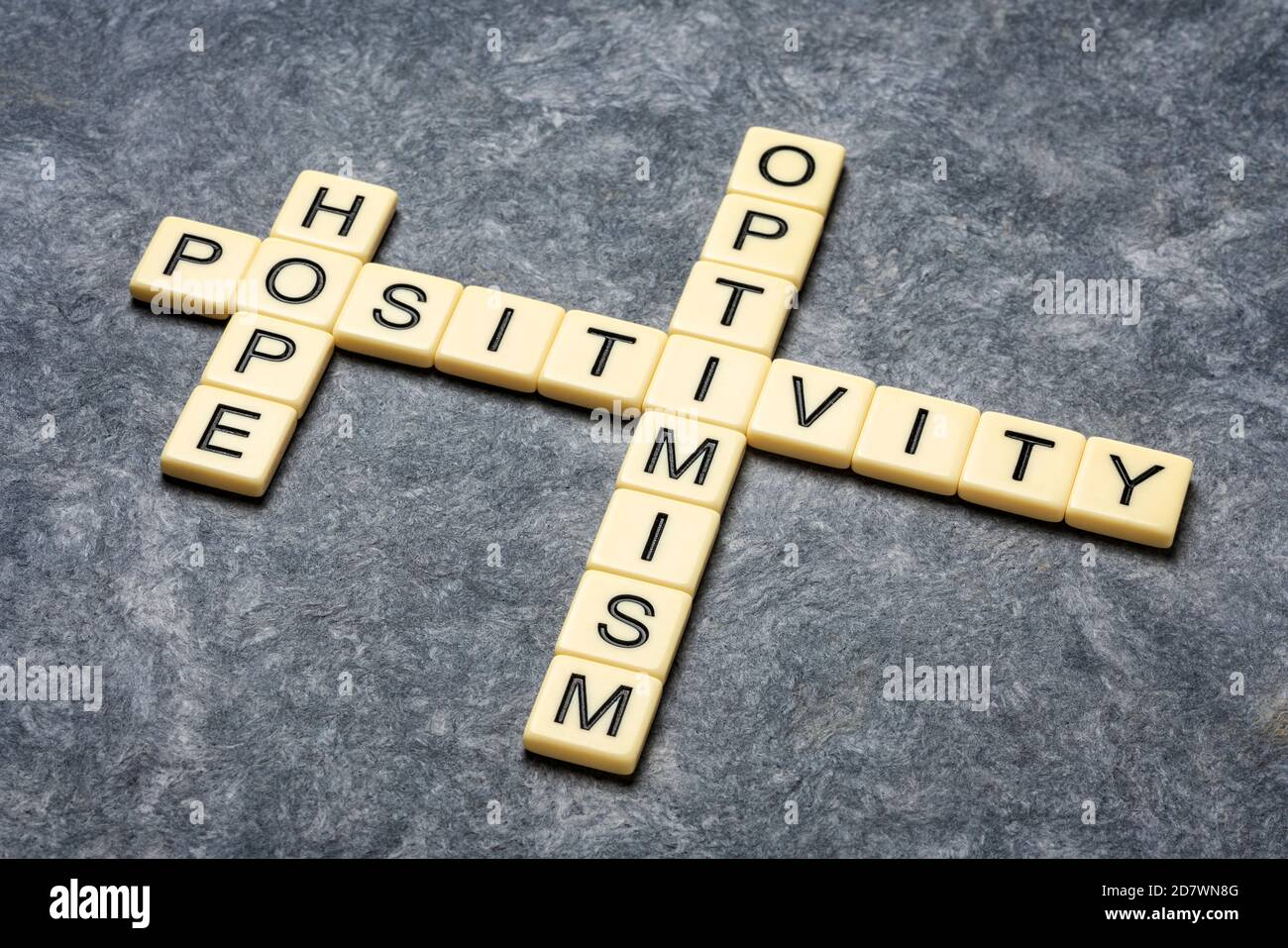 hope, positivity and optimism crossword in ivory letter tiles against