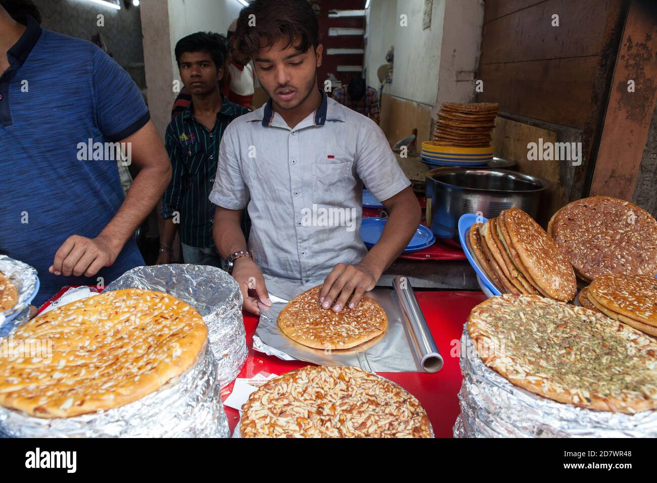 A worker wraps sheermal flatbread for sale in a muslim bakery in Delhi