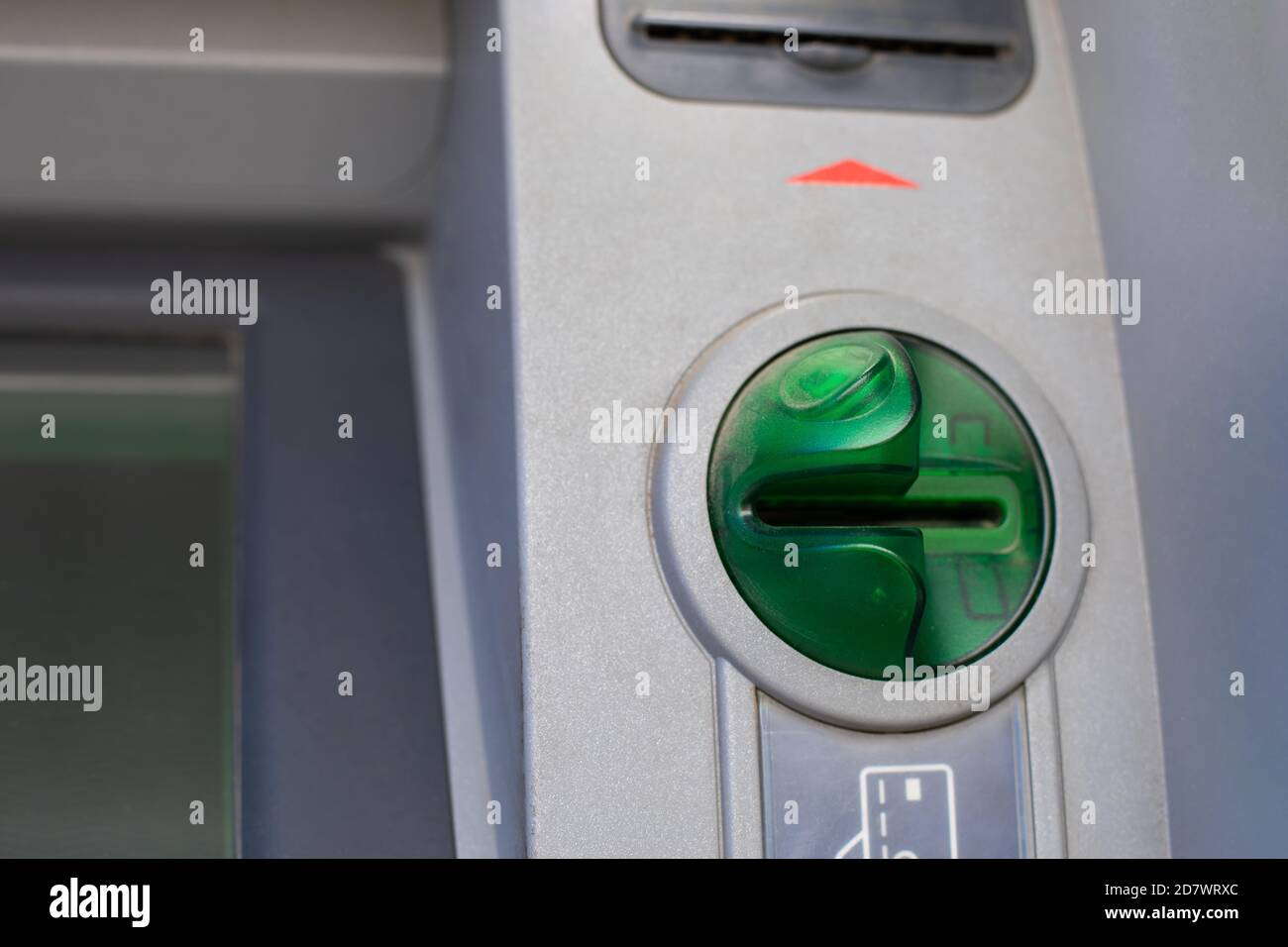 Closeup ATM card reader, green credit card reader with fraud