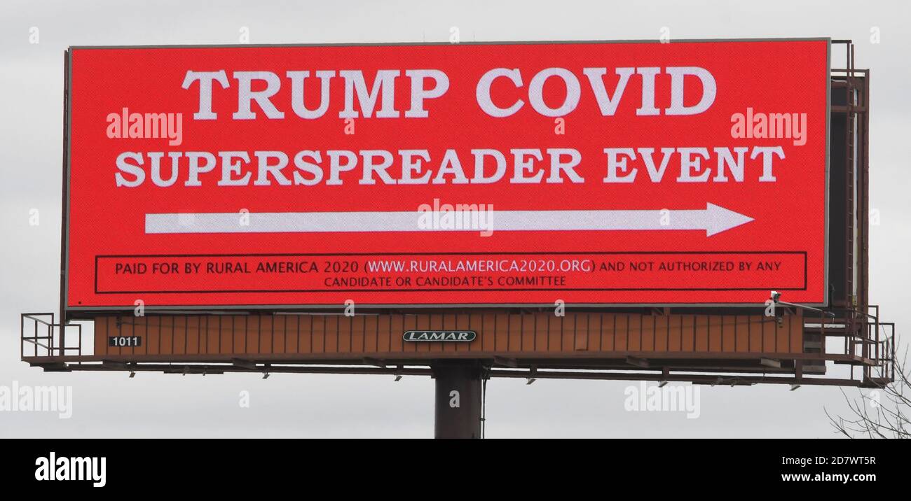 Waukesha, Wisconsin, USA. 25th Oct, 2020. A billboard along I-94 points the way to Waukesha County Airport where President Trump held a large outdoor rally the evening before. The sign was in place before the rally. Wisconsin had the third-highest rate of new per-person of cases in the nation last week, leaving contract tracers and many hospitals overwhelmed. (Credit Image: © Mark HertzbergZUMA Wire) Stock Photo