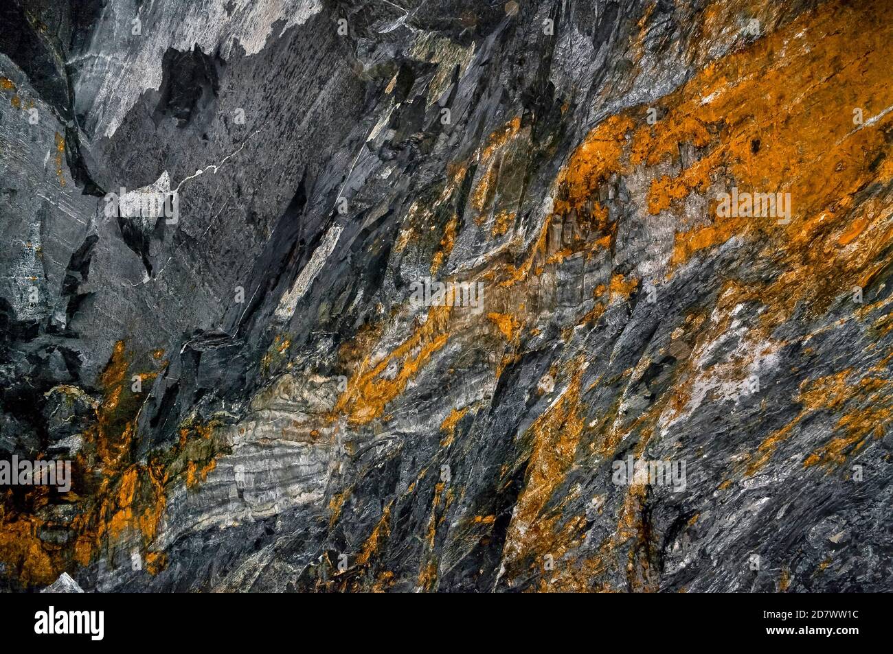 Abstract image of reflective slate blocks with mineral veins fallen from the roof in Croesor slate mine, North Wales. Stock Photo