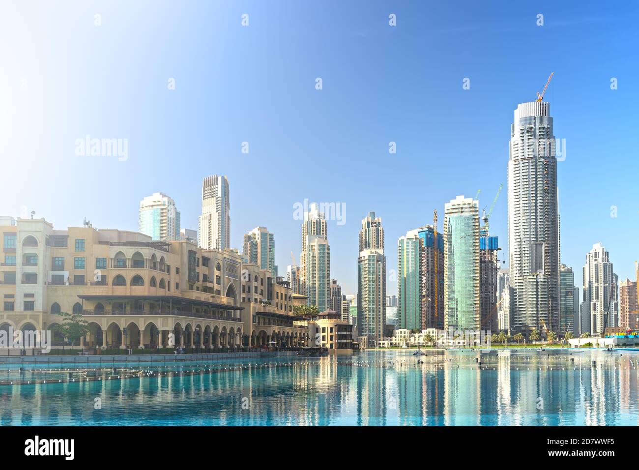 Downtown Dubai skyline in morning with high rise buildings reflected in pool water. United Arab Emirates, UAE. Stock Photo