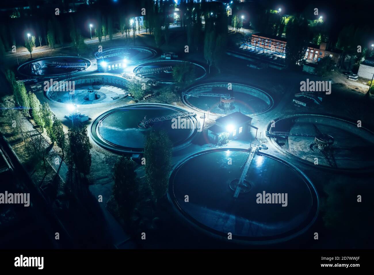 Wastewater treatment plant at night, aerial view. Reservoir for purification of sewage. Stock Photo