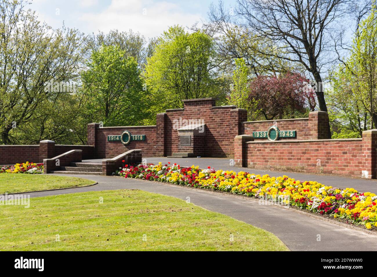 Colourful flower beds in the Garden of Remembrance war memorial in Farnworth Central Park, Bolton, Greater Manchester. Stock Photo