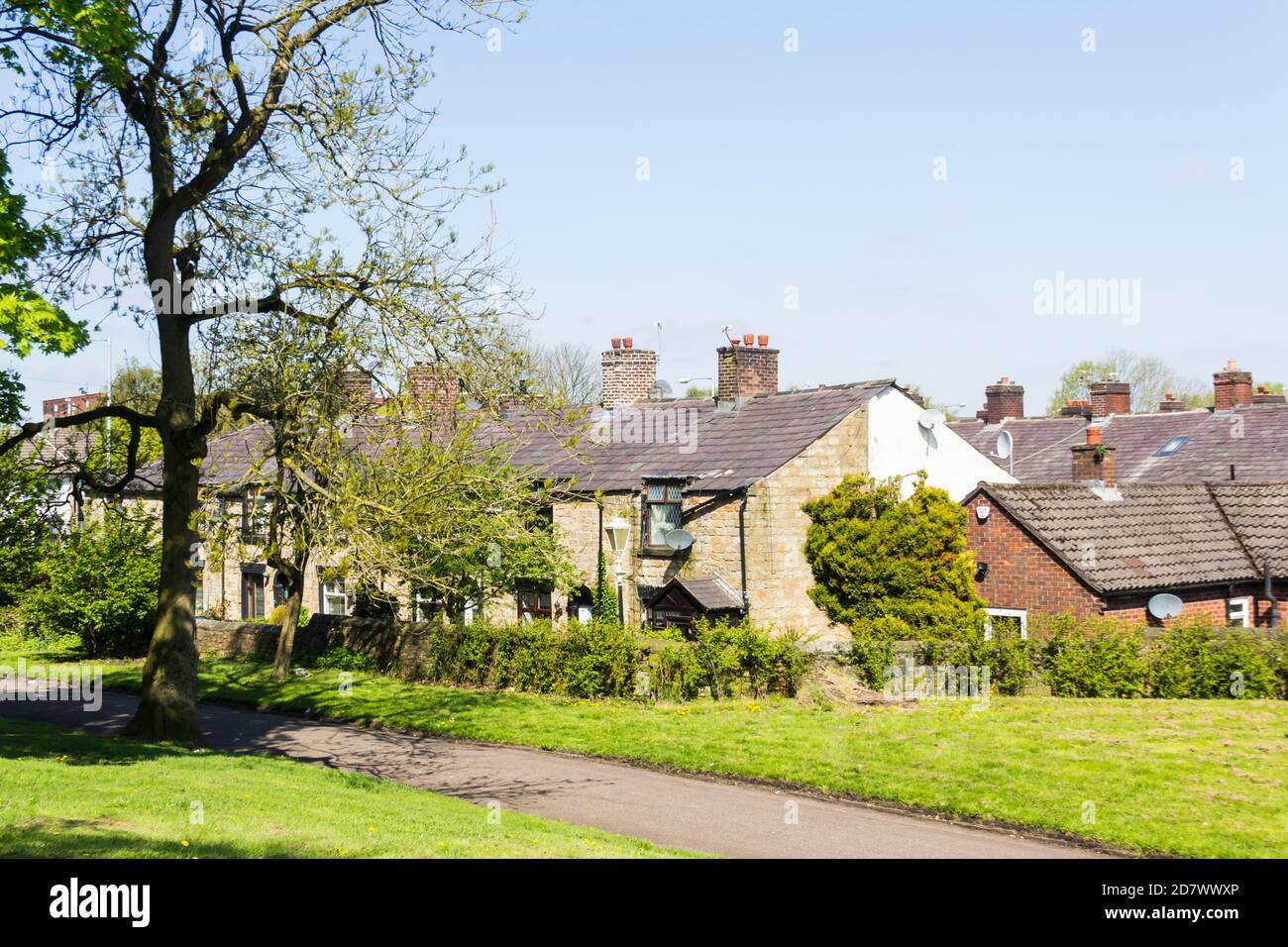 Early 19th century stone cottages, formerly mill worker homes on Greenside, Farnworth, a conservation area on the edge of Farnworth central park. Stock Photo