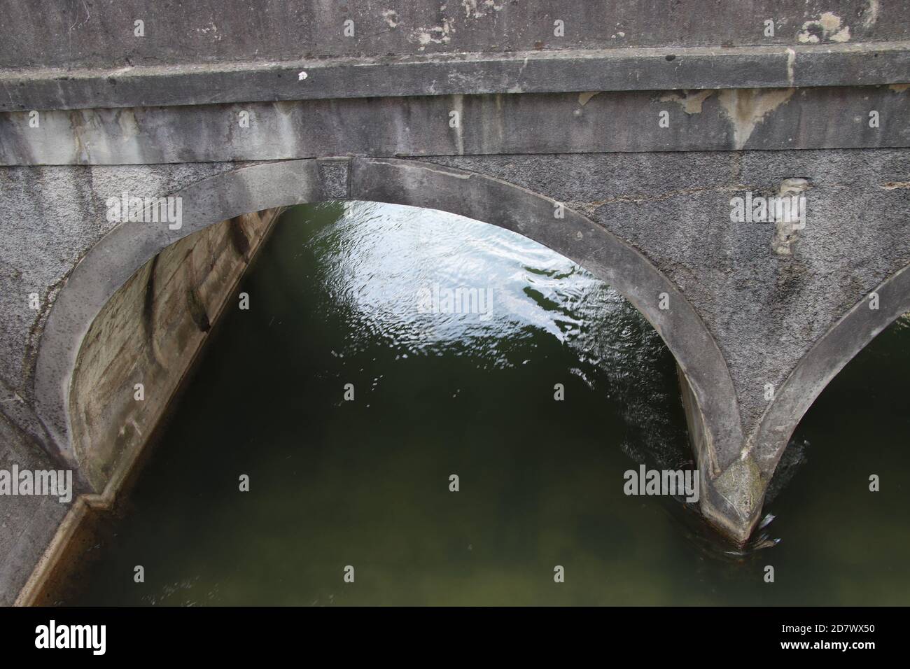 A very old stone bridge close up of the arch and under the bridge with ...