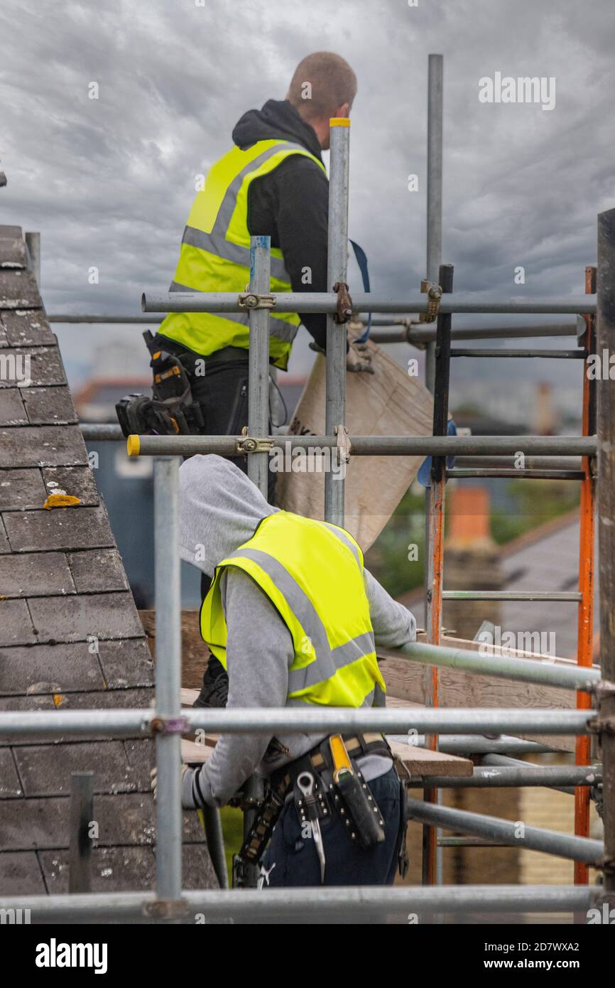 Scaffolders prepare scaffolding high up over London Stock Photo