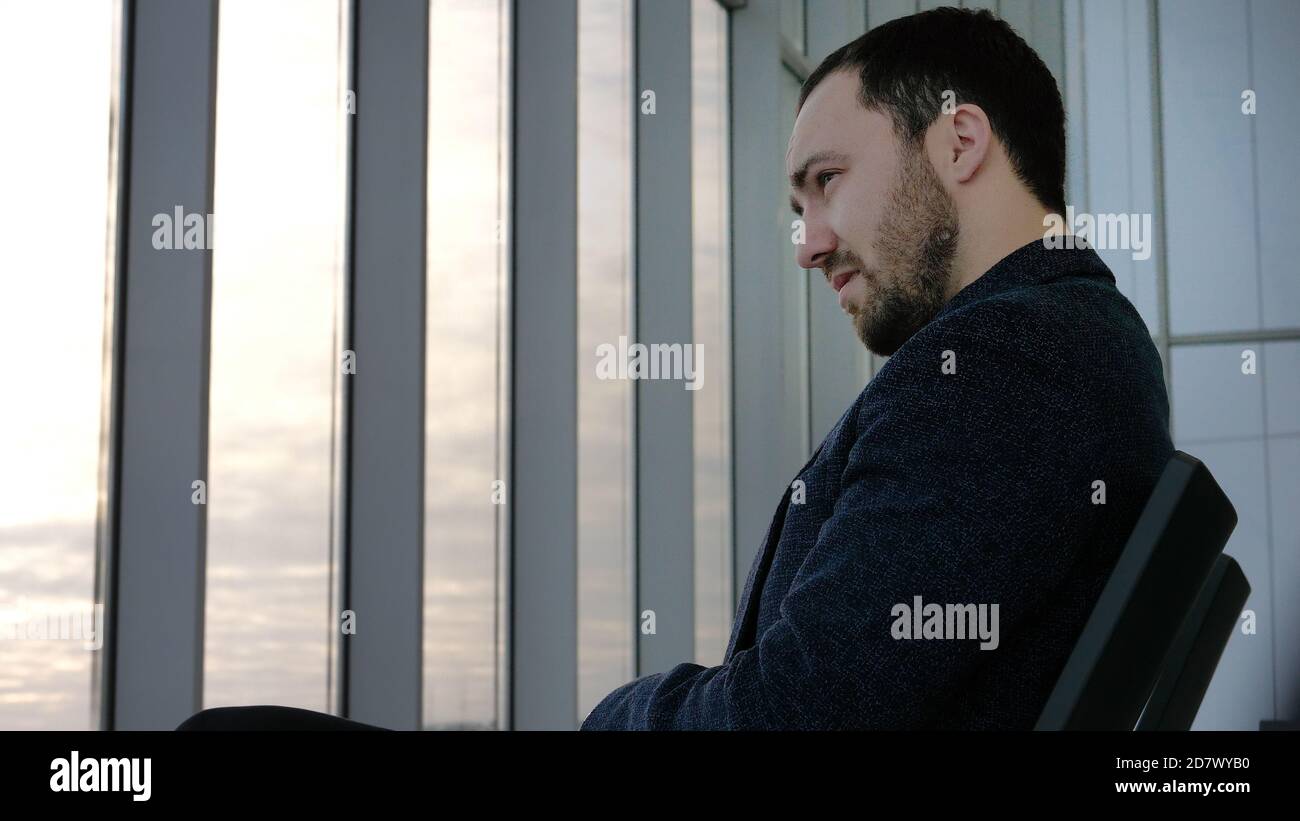 Tired man waiting for delayed flight. Stock Photo