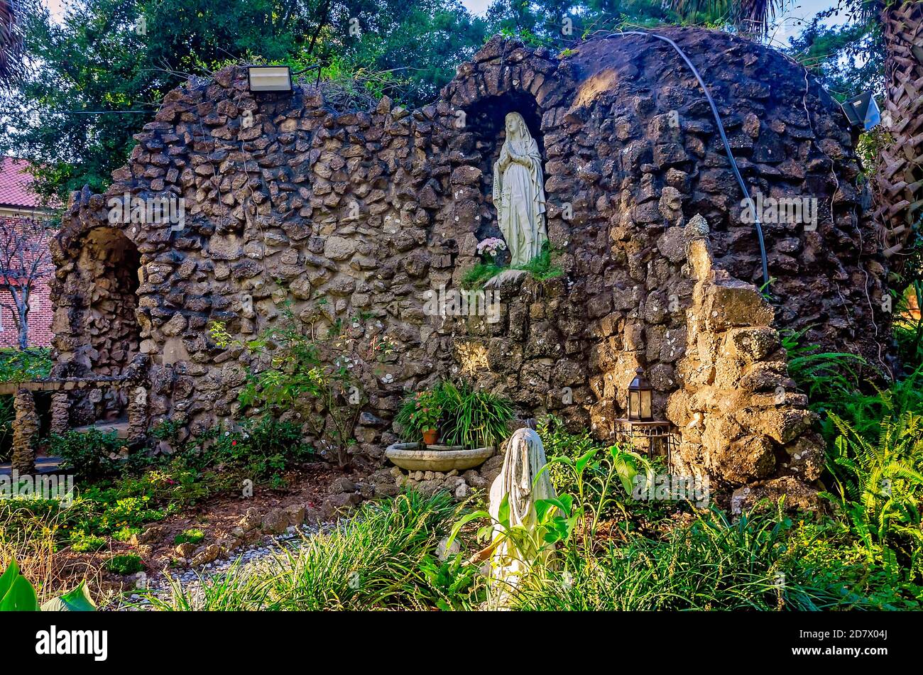 The sun sets on the Lourdes Grotto at St. Augustine’s Seminary, Oct. 24, 2020, in Bay Saint Louis, Mississippi.  The grotto was built in 1938. Stock Photo
