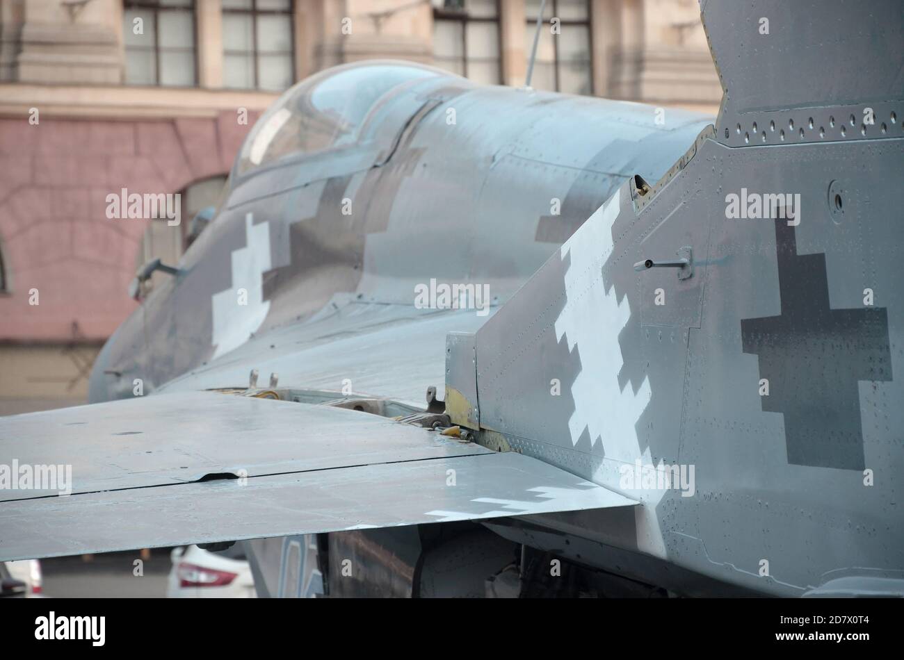 Old fighter aircraft painted in grey camouflage shapes with many small