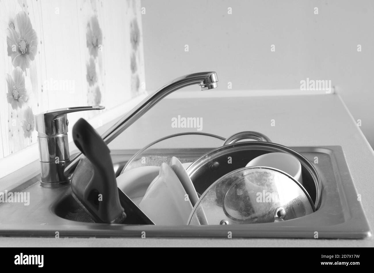 Dirty dishes and unwashed kitchen appliances filled the kitchen sink