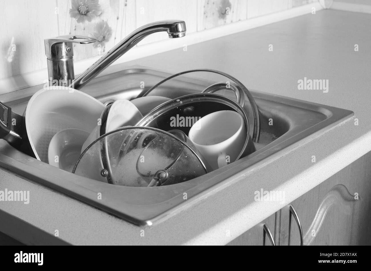 Dirty dishes and unwashed kitchen appliances filled the kitchen sink