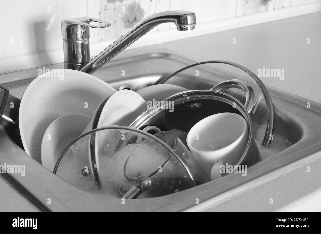 Dirty dishes and unwashed kitchen appliances filled the kitchen sink