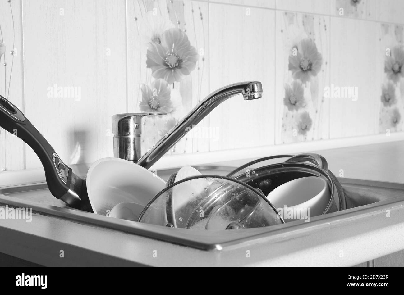 Dirty dishes and unwashed kitchen appliances filled the kitchen sink