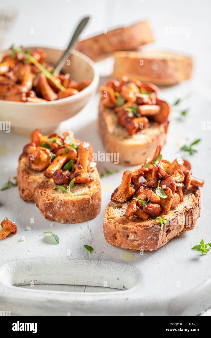 Rustic Toast with chanterelles, thyme and parmesan cheese on white