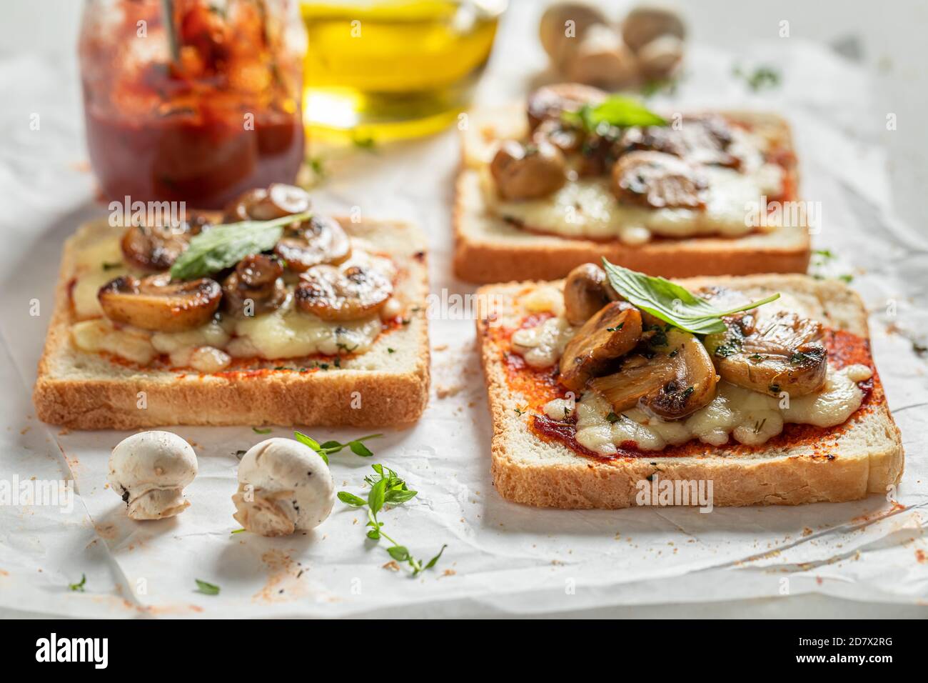 Rustic Toast with mushrooms, basil and cheese on white paper Stock ...