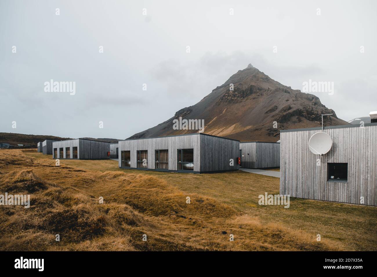 Iceland modern cottage house for tourist with beautiful mountain background Stock Photo