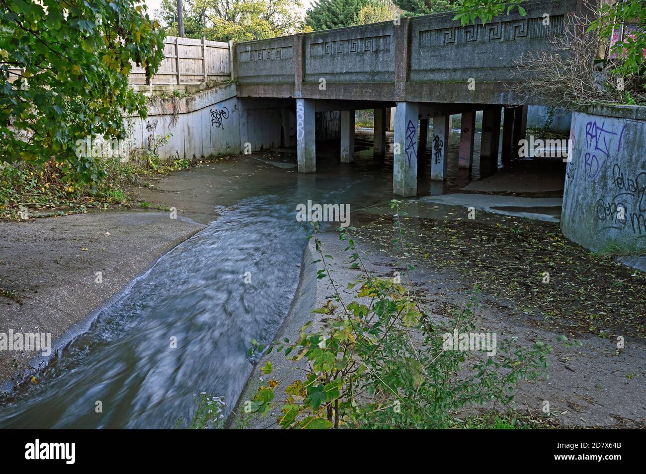 The River Crouch flows through the concrete channel under the London Road Bridge, Wickford, Essex. UK Stock Photo