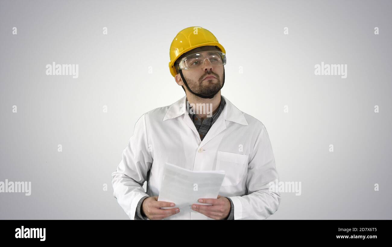 Site engineer cheching papers and something around him on gradie Stock Photo