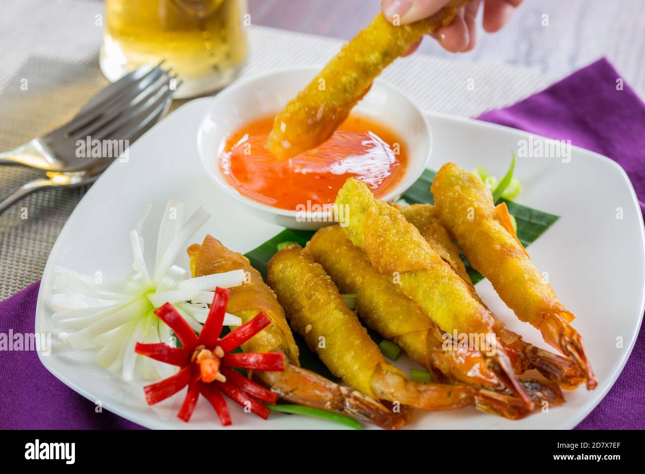 Prawn spring rolls dipping in sweet chilli sauce Stock Photo Alamy