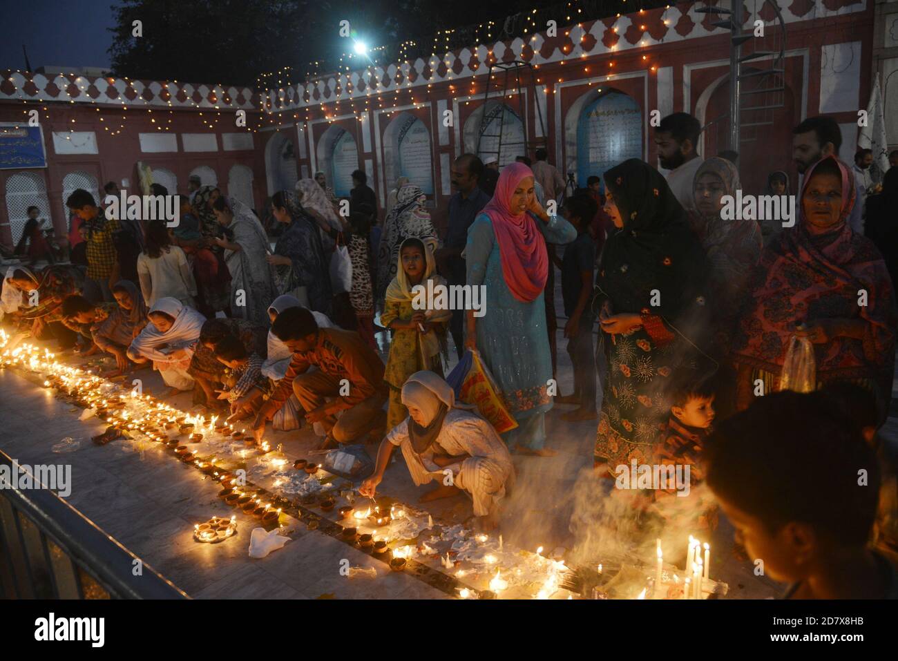Pakistani Muslim devotees light candles and earthen lamps at the shrine of  famous fifteenth century Sufi Saint Hazrat Mir Mohammed Muayyinul during  397th URS celebrations in Lahore. Thousands of people across the