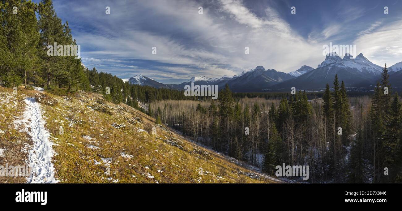 Snowy Hiking Trail and Distant Rocky Mountain Peaks Panoramic Landscape above Bow Valley, Alberta Foothills of Canadian Rockies Stock Photo