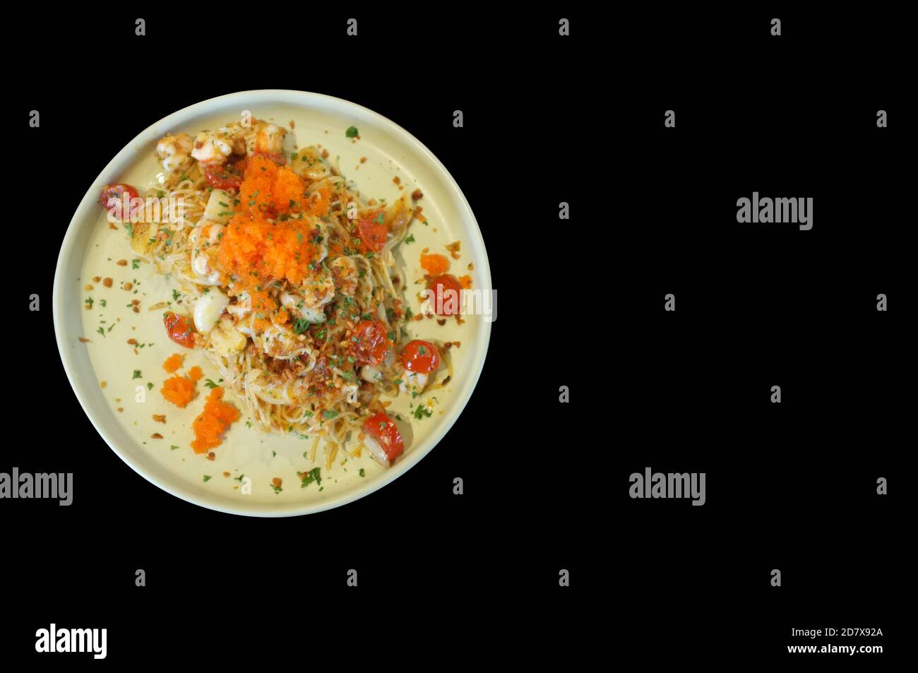 fusion food style , Cream sauce spaghetti egg shrimp on black background Stock Photo