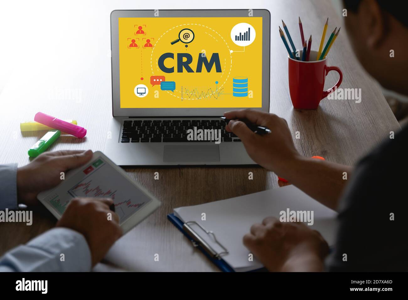 CRM Business Customer CRM Management Analysis Service Concept Business team hands at work with financial reports and a laptop Stock Photo
