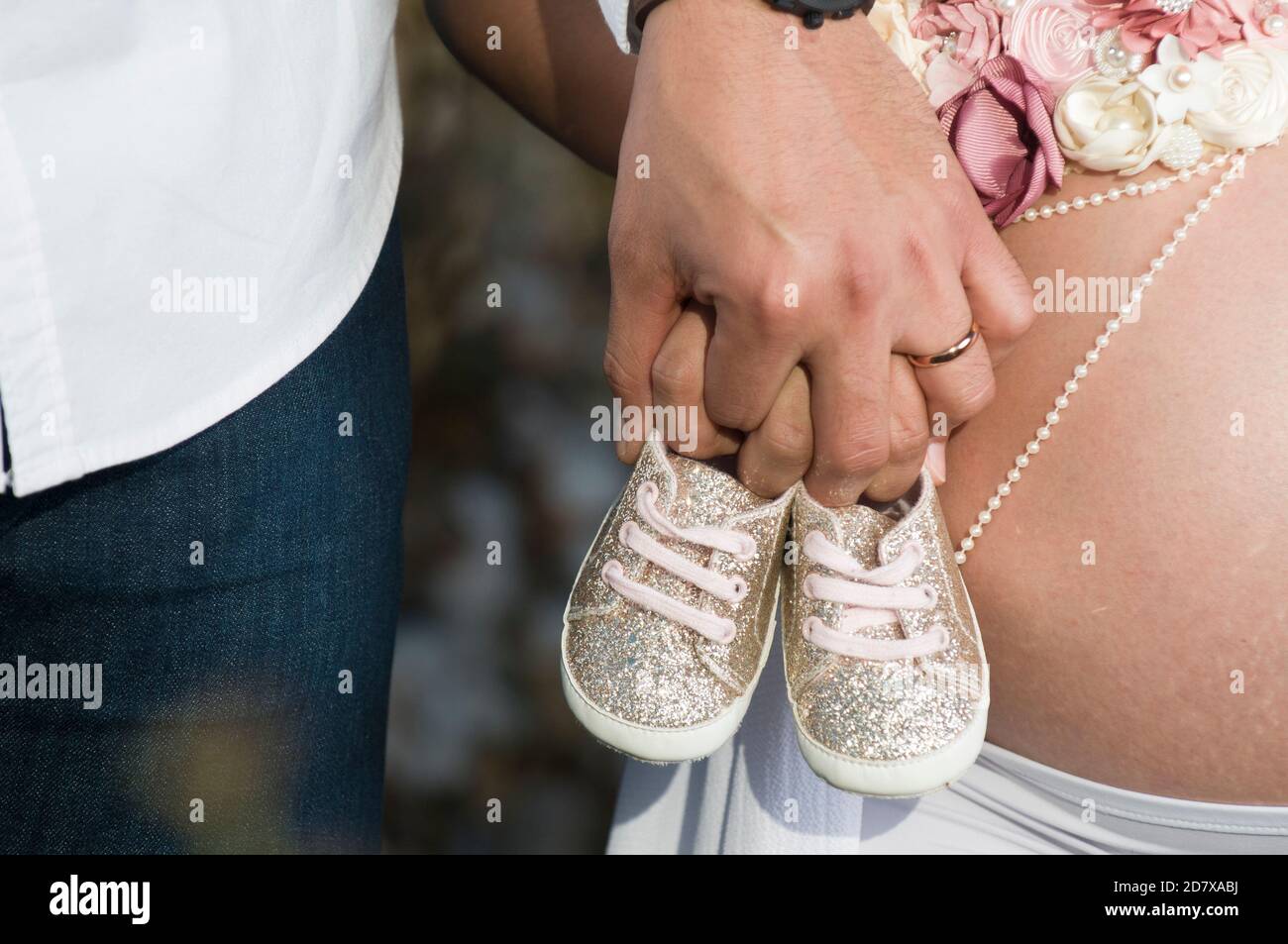 Couple in love, waiting for their baby holding a pair of