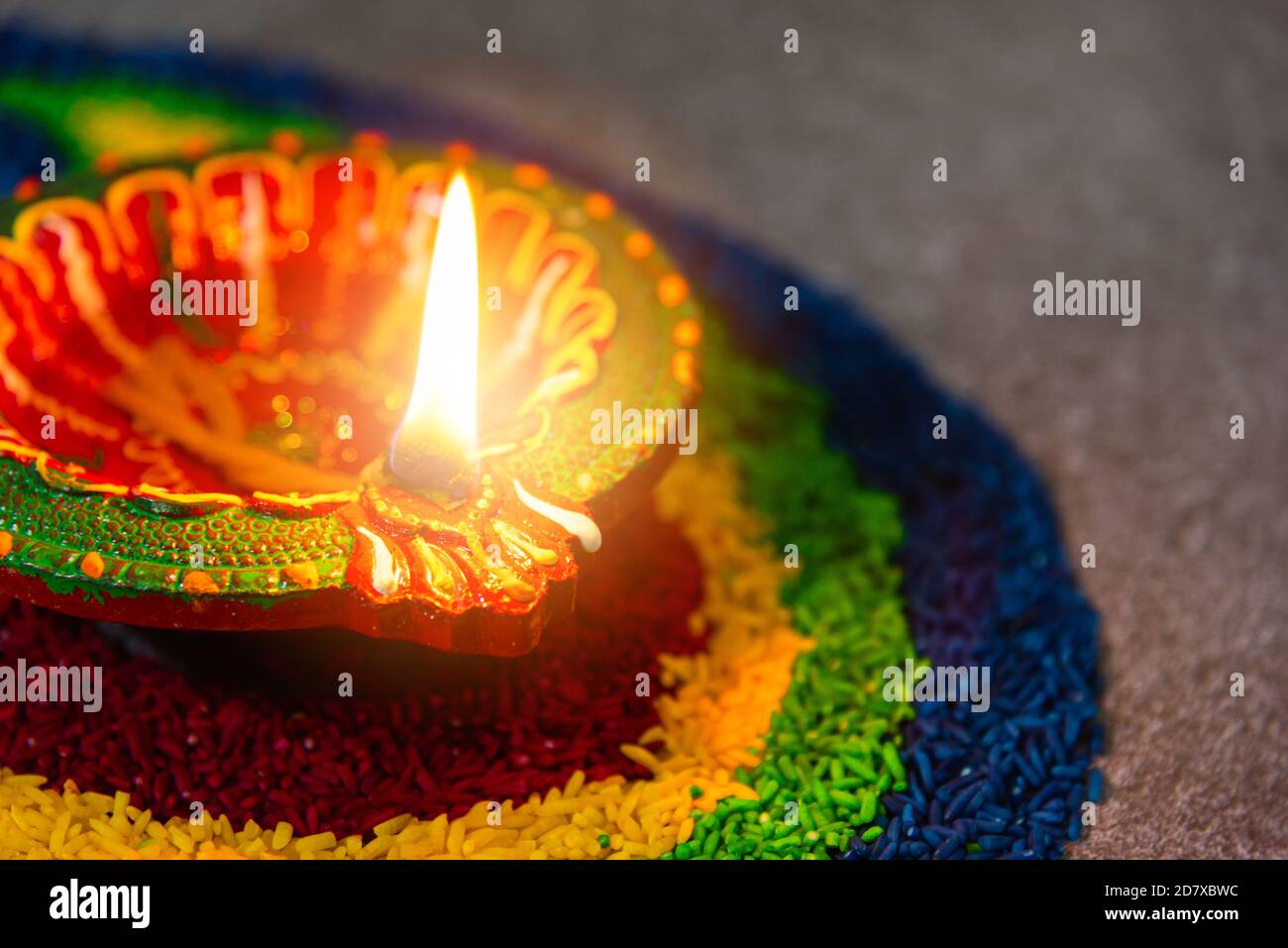 Close up clay lit light a fire already on Diya or oil lamp on concrete ...