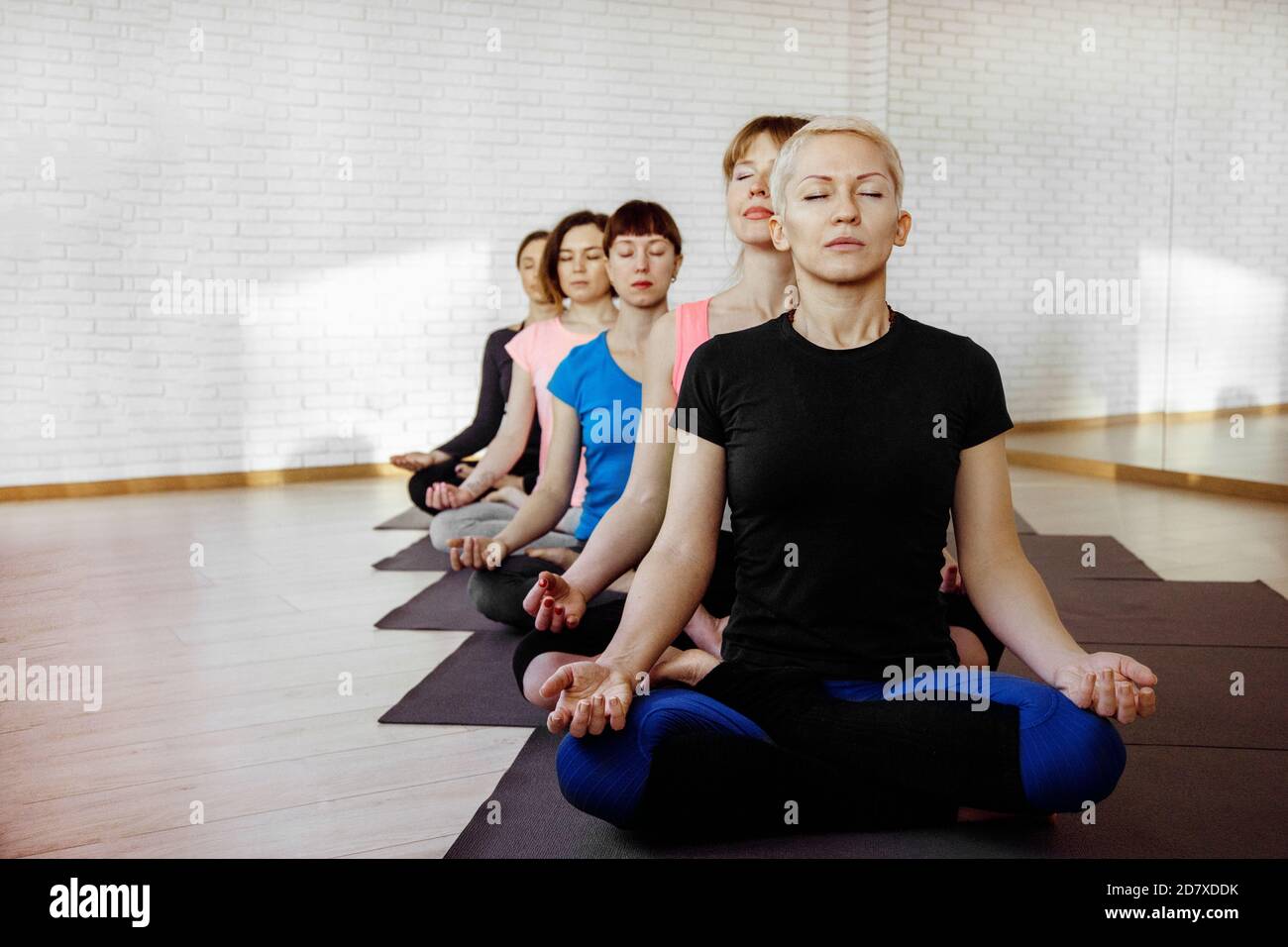 Women are sitting in a lotus position Stock Photo